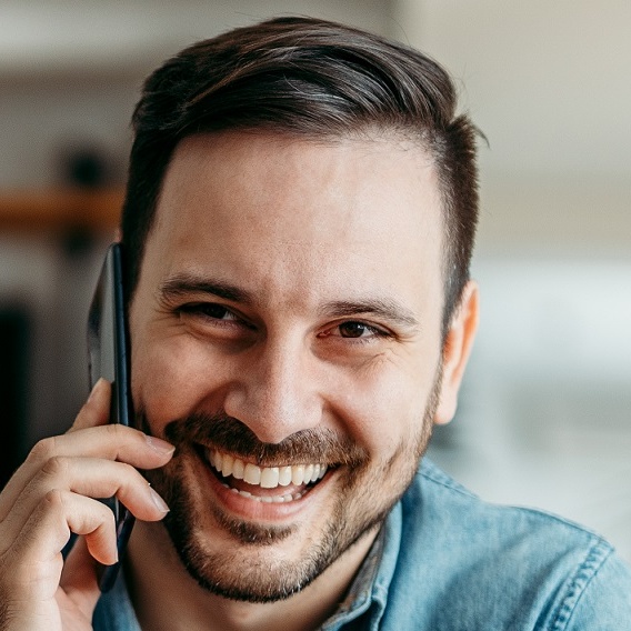 portrait of a happy casual man talking on smart ph 2022 12 18 17 30 35 utc cropped.jpg